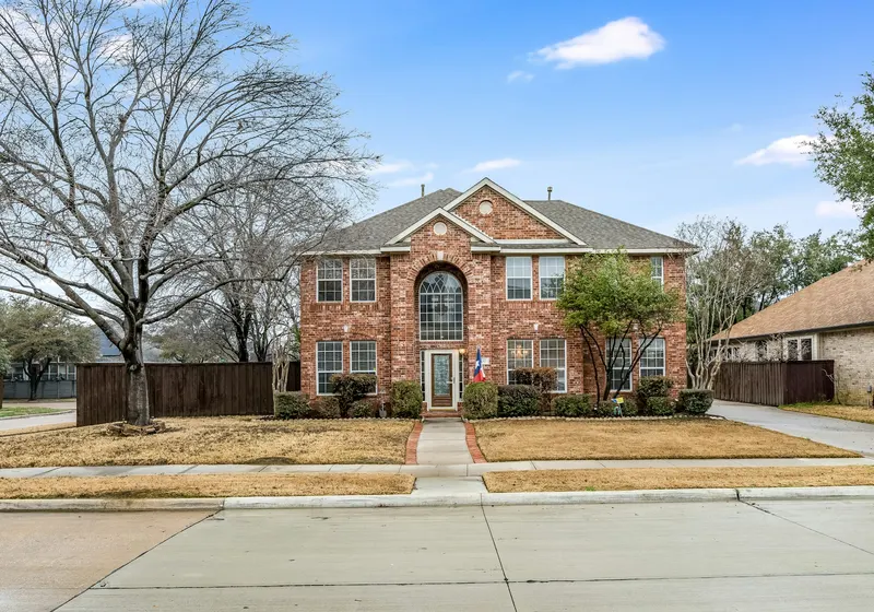 Two-storey brick house with a front lawn
